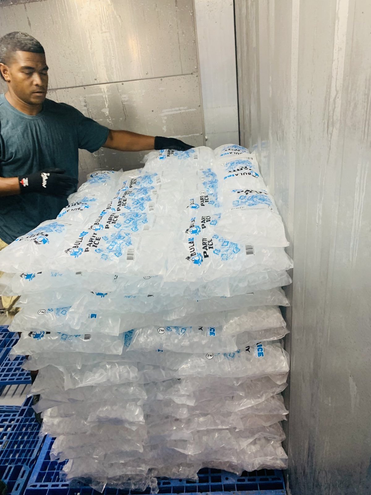 Stacking a pallet of Party Ice in the cold room